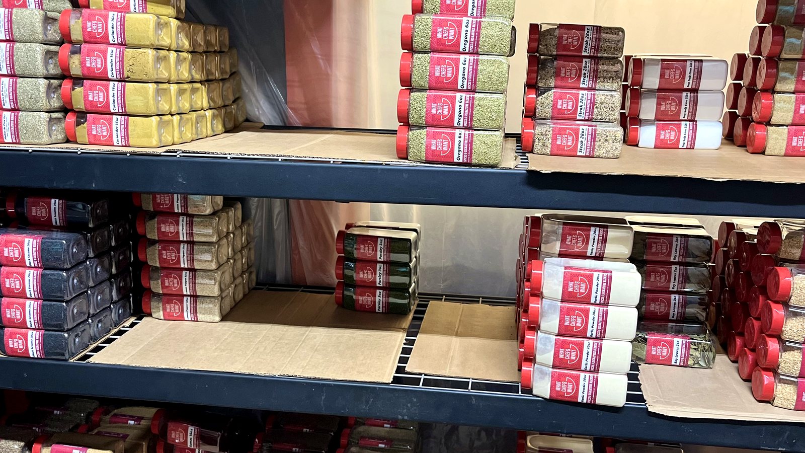 Shelves stocked with spice bottles and wholesale spice products